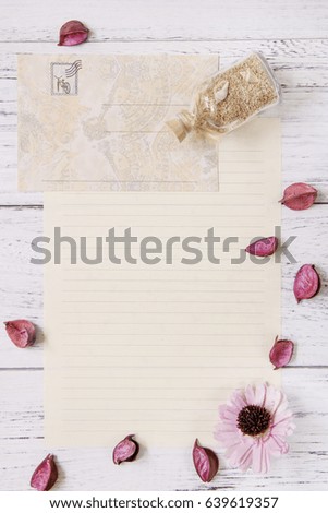 Flat lay stock photography purple flower petals letter envelope paper glass bottle sea sand