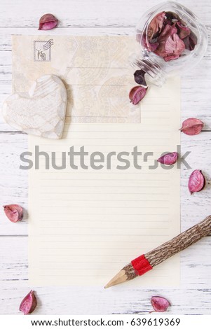 Flat lay stock photography purple flower petals letter envelope paper glass bottle wood pencil heart craft decoration