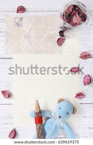 Flat lay stock photography purple flower petals letter envelope paper glass bottle bear doll wood pencil