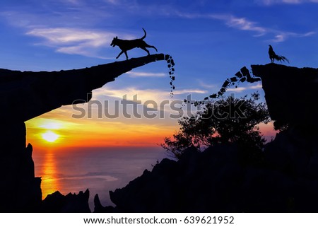 New year 2018 concept. Dog and rooster on the broken stone bridge silhouette background.



