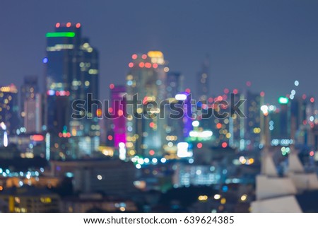 Blurred bokeh light night Office building downtown, abstract background