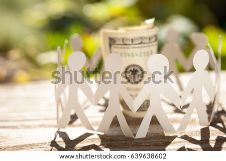 Concept of business teamwork with paper stickman around money bill