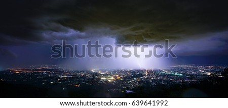 Lightning storm over city in purple light Royalty-Free Stock Photo #639641992
