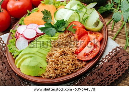 
 Buddha Quinoa bowl of mixed vegetable on the wooden table.
