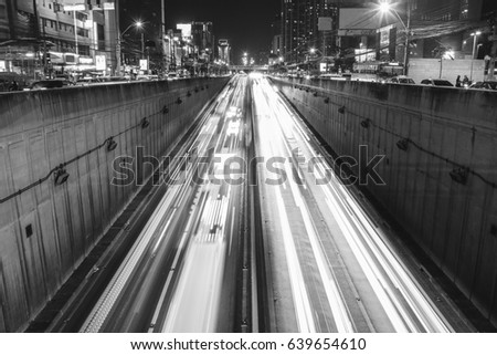 black and white low speed shutter line of light at highway tunnel in Bangkok Thailand