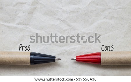 Part of pens on brown paper with word 'Pros and Cons', decision and comparision concept  Royalty-Free Stock Photo #639658438