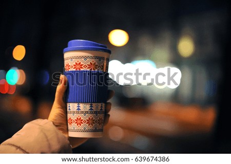 Hot coffee in a beautiful ?up on a background of evening lights