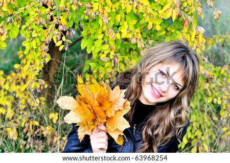 sweet girl in fall forest with leaves