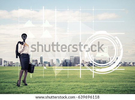 Elegant businesswoman outdoors with camera instead of head and media interface on screen