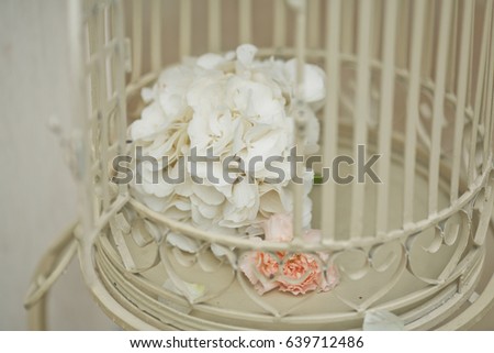 White hydrangeas in white bird cage
