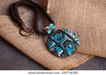 Boho jewelry.Turquoise and brown handmade pendant. Fashion background. Polymer clay jewelry. Summer accessory.