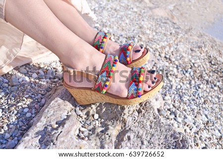 greek sandals advertisement on the beach