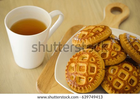 Morning tea with biscuits. On a light wooden table