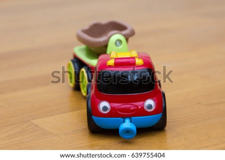 Red Little toy car with a trailer