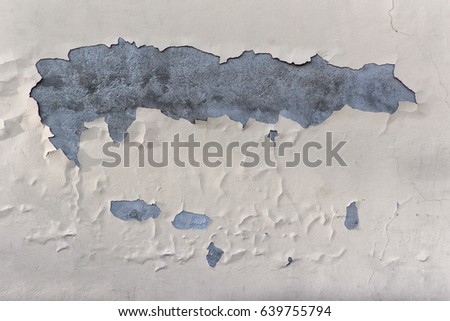 Texture of an old wall with decaying paint and see through gray concrete.