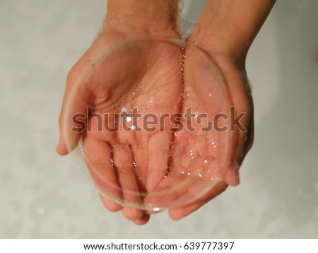 Big bubble in child hand. Clean in bath