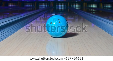 Blue bowling ball on the track. Active leisure. Sport game.