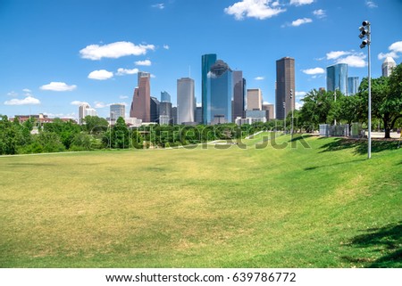 Downtown Houston at daytime with cloud blue sky. Green park lawn and modern skylines. It is the most populous city in Texas and the fourth-most in United States. Architecture and travel background.