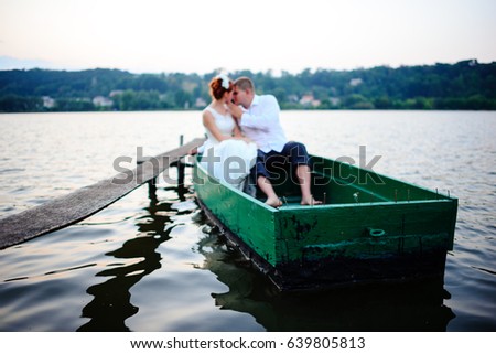 Young couple in love on sail boat having fun with tablet - Happy luxury lifestyle on yacht sailboat - Always connected people interacting with satellite wifi connection - Warm retro contrast filter.