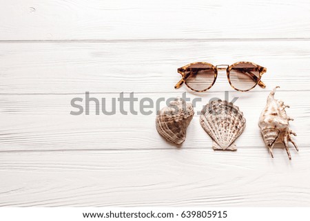 shells and sunglasses on white background with space for text, summer vacation concept, top view. summertime holiday picture, wanderlust and travel. flat lay