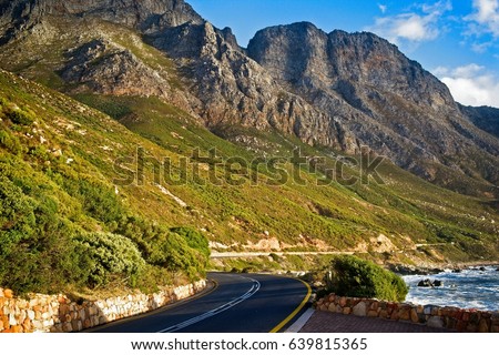 The green and rocky hilly slopes along the beautiful and scenic coastal road of the Garden Route, Cape Town, South Africa. Royalty-Free Stock Photo #639815365