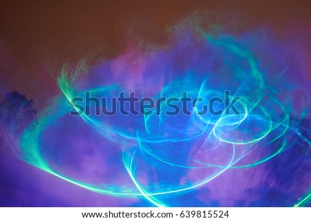 Abstract round laser show. Blue and green laser rays. Disco club illumination