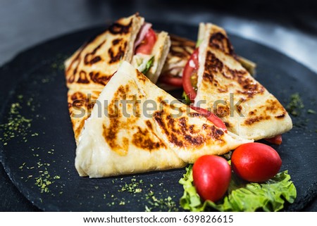 Sandwich bread, tomato, lettuce and yellow cheese. Top view of Healthy Sandwich toast with lettuce, ham, cheese and tomato on the plate.