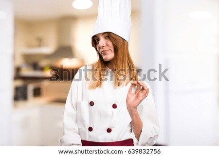 Beautiful chef woman proud of herself in the kitchen