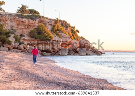 Woman on the seaside at the sunsrise