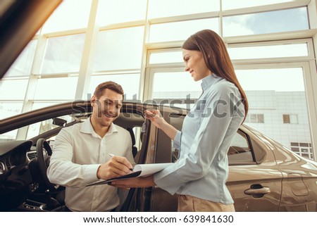 Young Man in a Car Rental Service Test Drive Concept
