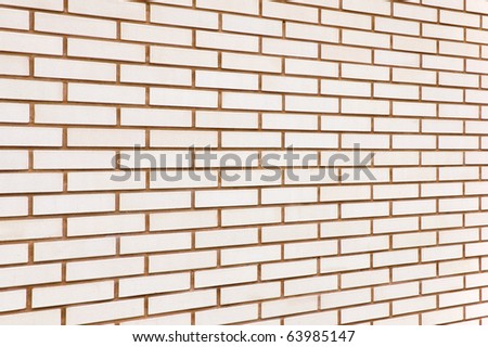 Natural beige colored fine brick wall texture background perspective, large