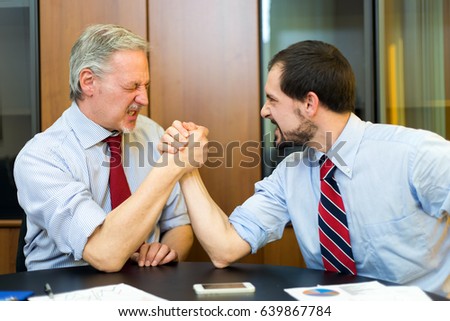 Arm wrestling between businessmen