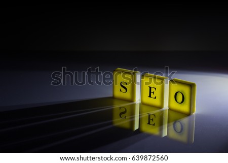 Word Letters was Arranged as SEO abbreviation (Search Engine Optimization) with reflection on Ground in Darkness and Spotlight from Back. Set as Copy Space for Text.