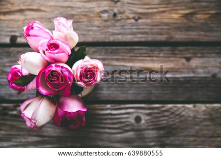 Pink roses on a wooden table. Vintage. flowers