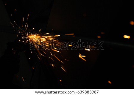 Bright blue and yellow sparks on a black background. Magical lig Royalty-Free Stock Photo #639883987
