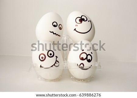 An egg with a face. Funny and cute. FOUR EGGS. DORMITORY. ON THE HEADS OF NEIGHBORS. CLOSELY. EMIGRANT. POLICY. Photo for your design.