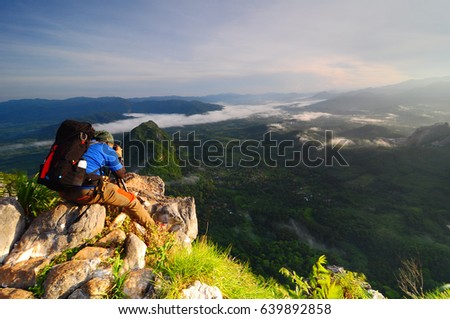 Mountain Photographer taking a shot above the mountain