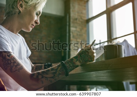 Fashion designer tattooed girl drawing cloth pattern
