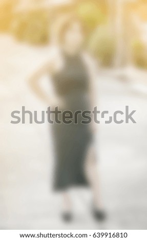 blur background of woman standing with dress at outdoor daylight village background.