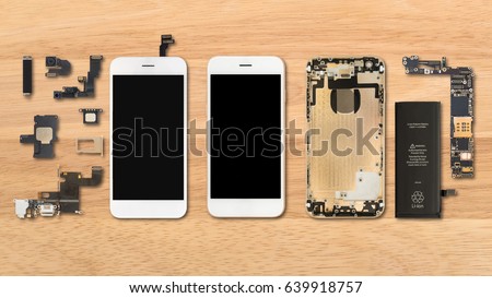 Flat Lay (Top view) of smartphone components on wooden background Royalty-Free Stock Photo #639918757