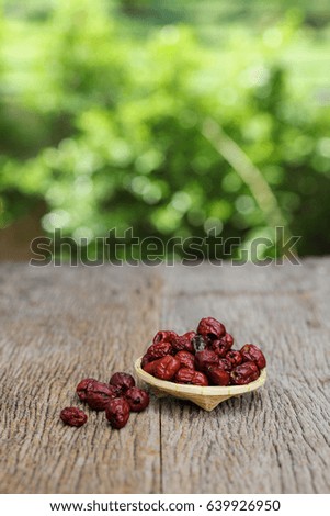 Dried red date or Chinese jujube on wooden table, selective focus