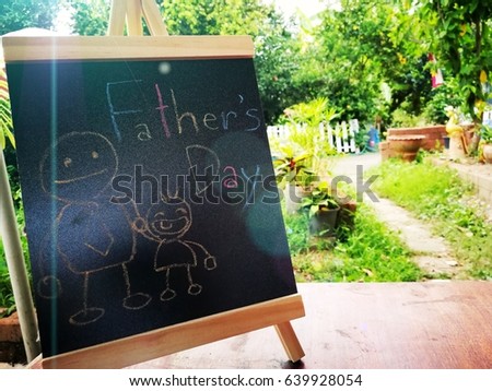 chalkboard with text father's day with cartoon doodle father and son on green nature gardening flare light background concept for holiday, calendar, weekend celebrate