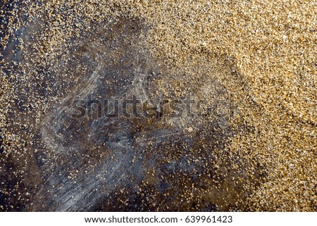 Golden background - dust of gold over black background