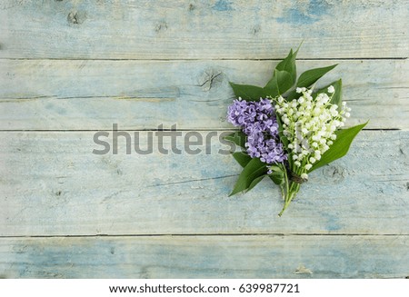 Bouquet of flowers lily of the valley on turquoise rustic table. Greeting card for Valentine's Day, Woman's Day and Mother's Day holidays. Spring background. Top view.