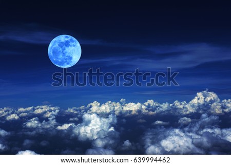 Blue moon and cloud  in the dark sky at night , color effect