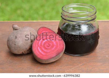 Beetroot juice and Fresh Beetroot, Healthy drink on table in a countryside garden.