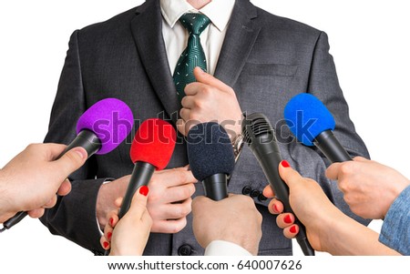 Reporters with microphones making interview with businessman - journalism and broadcasting concept