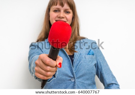 Female reporter at press conference with microphone - journalism and broadcasting concept