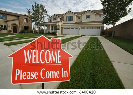 Welcome, Please Come In Real Estate Sign with new home in the background.