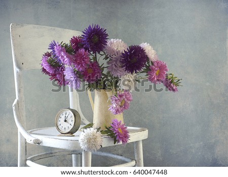 Aster bouquet in the vase on the table